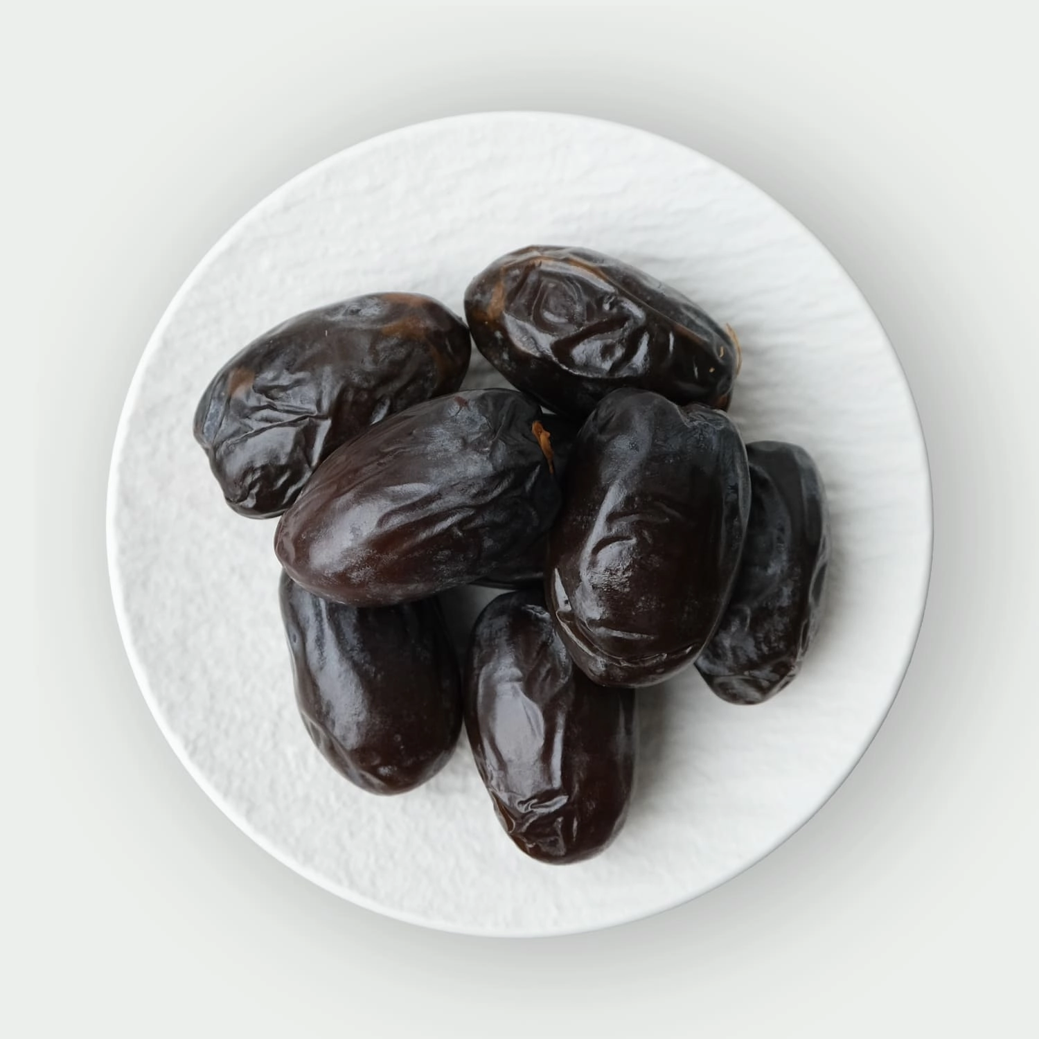 Large dark king dates on a plate