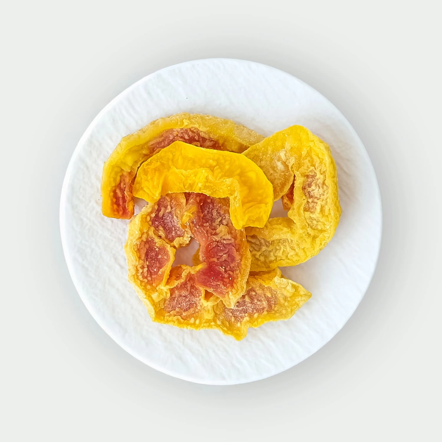Dried papaya slices on a plate
